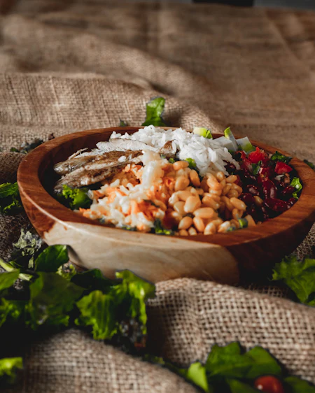 Ember-cooked barley with beetroot salsa and smoked yoghurt in a turned wooden bowl.